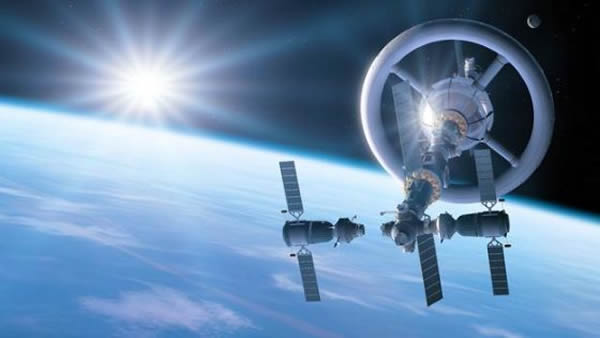 艺术概念图,展示了可产生人造重力的航天器,外形好似巨大的旋转轮