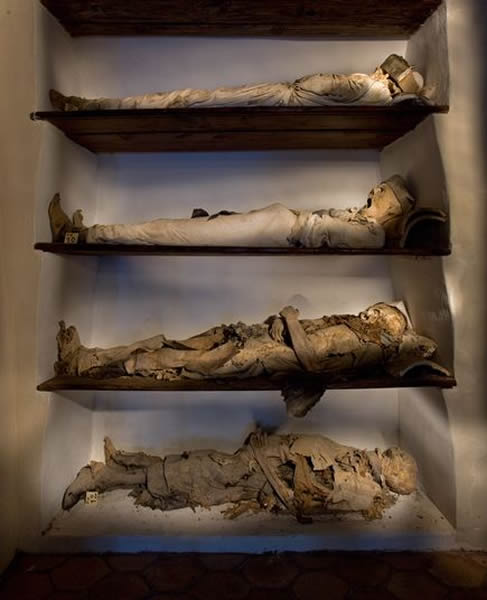 Mummies line the shelves of a crypt in Piraino, Sicily.