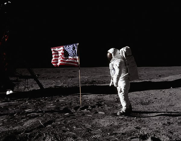 Buzz Aldrin stands with the US flag on the surface of the moon during the Apollo