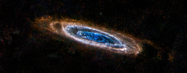 The ring-like swirls of dust filling the Andromeda galaxy stand out colorfully i