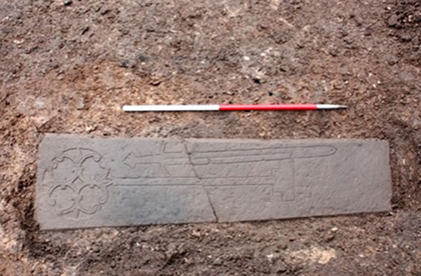 This carved slab, thought to be the headstone of a medieval knight, was found un