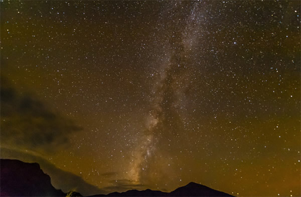 The glow of city lights obscure the view of the Milky Way.