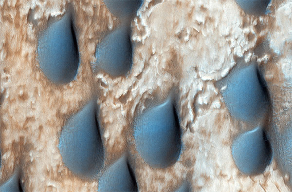 The dark features here look like raindrops on Mars, but are actually sand dunes