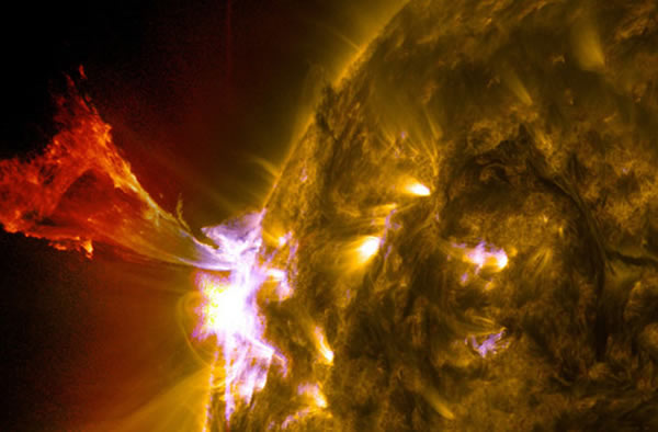 A burst of solar material leaps off the left side of the sun in whats known as