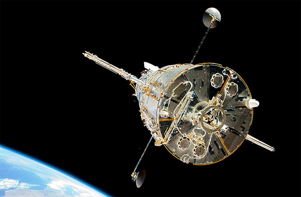 The Hubble Space Telescope as seen from behind in Earth orbit.