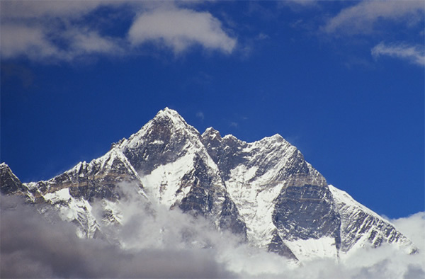 The summit of Mount Everest seen above clouds.