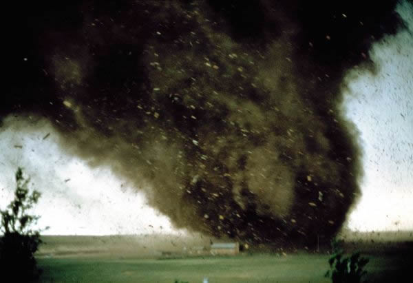 A tornado blasts through a mobile-home park near Cheyenne, Wyoming. Watching fro