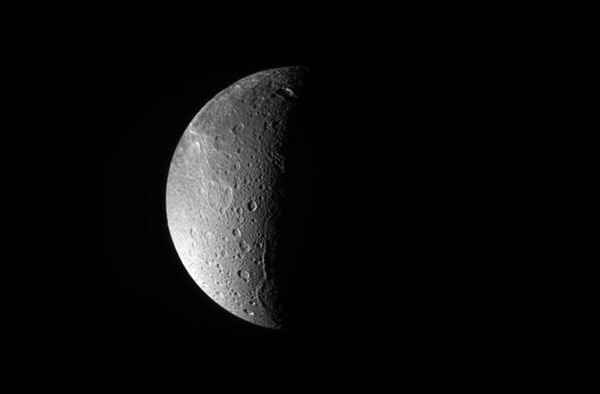 The Cassini spacecraft looks down, almost directly at the north pole of Dione. T