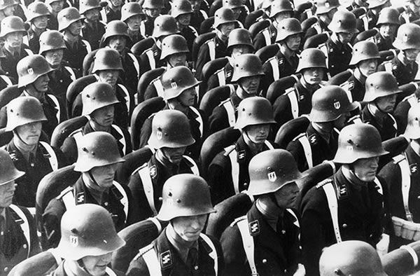 Rows of Nazi SS troops, also known as the Schutzstaffel, stand in uniform.
