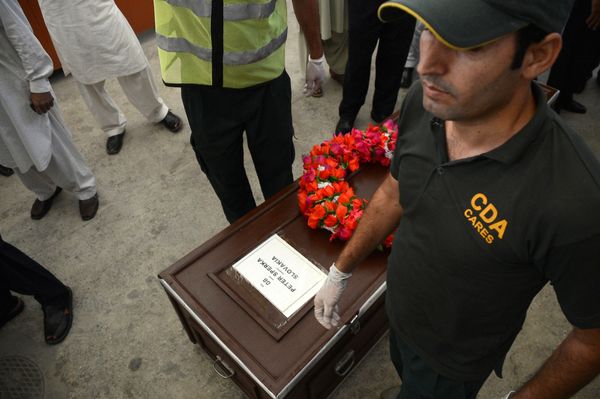 Pakistani rescuers stand by the coffin of a Slovakian climber killed by gunmen o