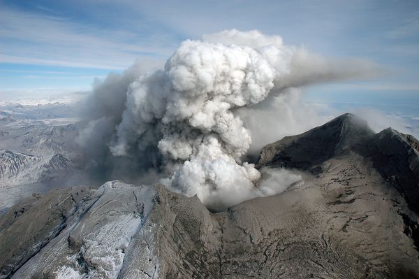 Redoubt volcano is shown heavily covered with deposits from recent eruptions.