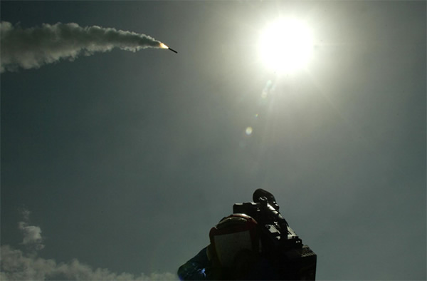 A cameraman films a Tomahawk cruise missile as it flies toward Iraq after being