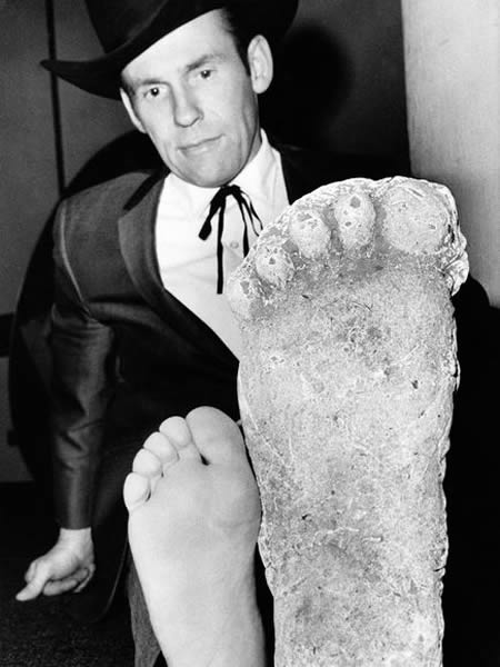 Photographer Roger Patterson compares his foot with cast in Los Angeles on Nov.