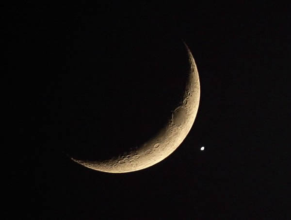 The planet Venus near a crescent moon. The two will share a close encounter on S