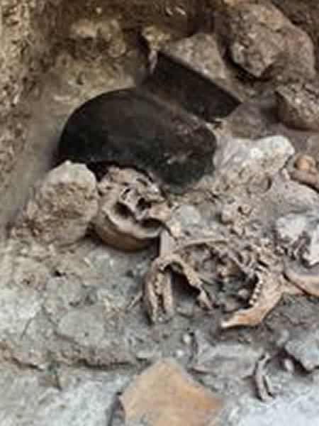 Human remains litter the floor of a cave at the site of Uxul. Photograph courtes