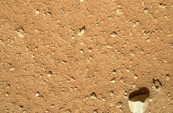 A view of the dry ground immediately in front of the Curiosity Mars rover.