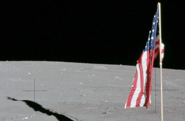 Detail from an Apollo 12 photo showing the deployed flag and its shadow. The lat