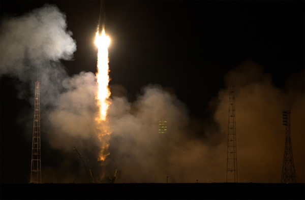 The Soyuz launch vehicle lights up the launchpad in the early hours of Wednesday