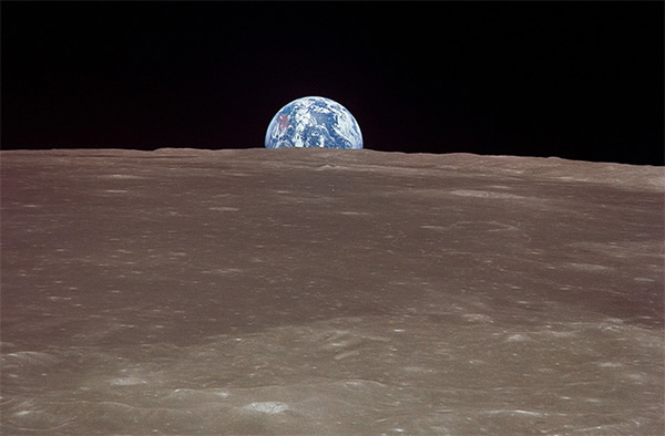 The Earth rises above the lunar horizon during the Apollo 11 mission in 1969.