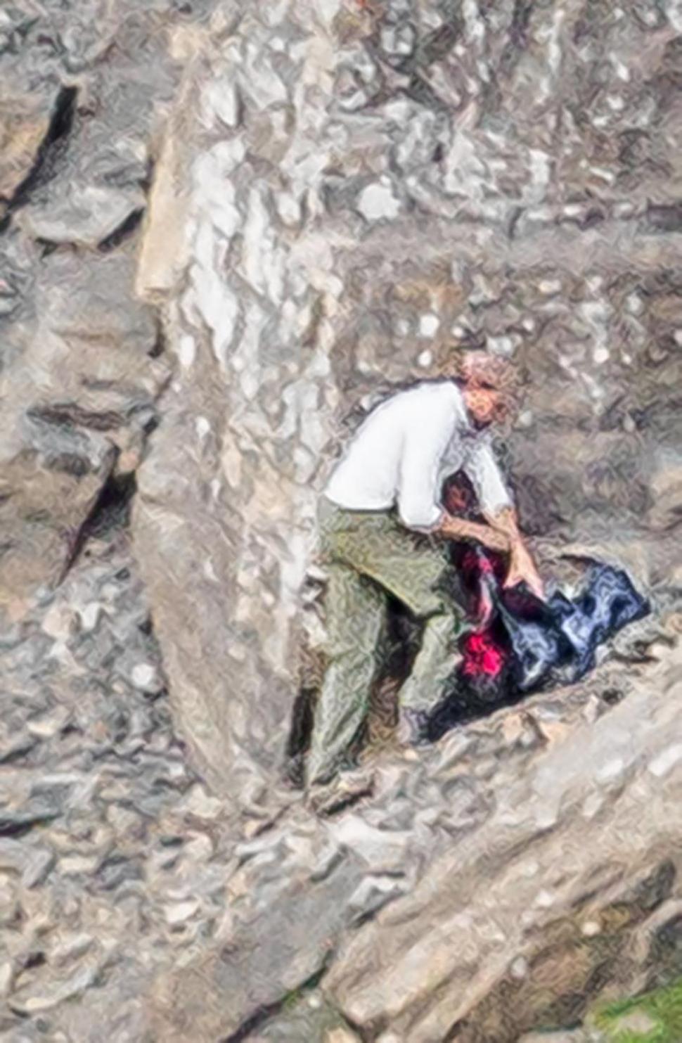 美国游客在峭壁狭窄山道上遇灰熊 躲悬崖角落求生