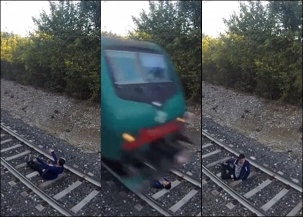 青年成功挑战死神,躺卧路轨上让列车高速驶过,但没有损伤。