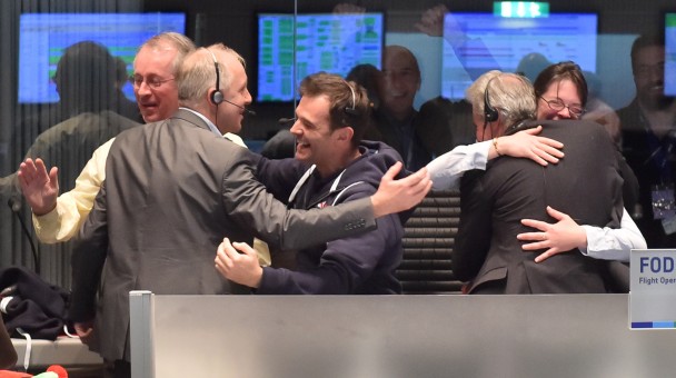 得知探索器菲兰成功登陆彗星67P,科学家们相拥庆祝。