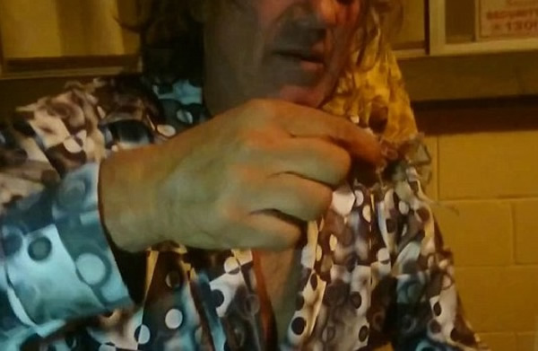 看着蜘蛛在杯中挣扎,男子乘势检起蜘蛛。