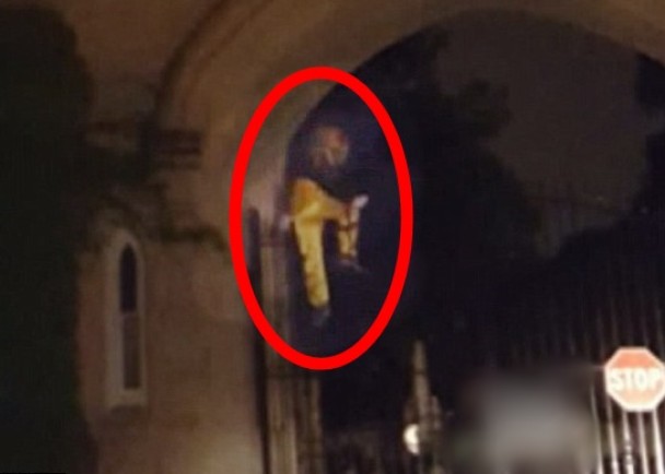 该名小丑攀过坟场的大闸