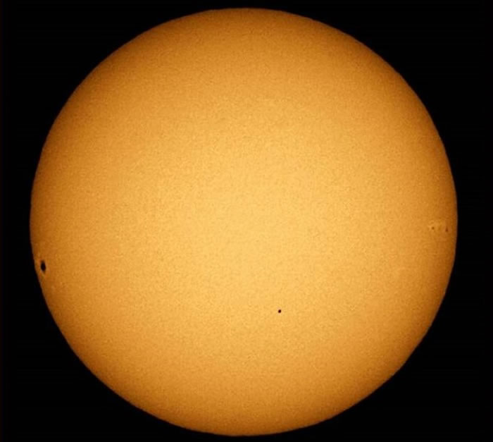 图为2006年11月8日发生的“水星凌日”。中间小黑点是水星投影,左侧较大黑点和右侧小黑点是太阳黑子。